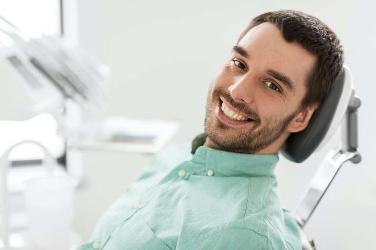 man smiling after going to scottsdale clinic for emergency dentistry