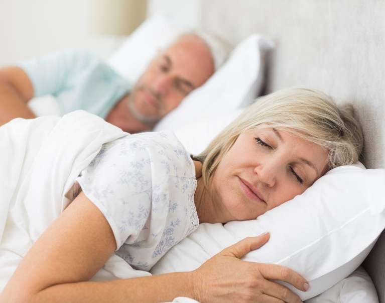 An older couple peacefully sleeping