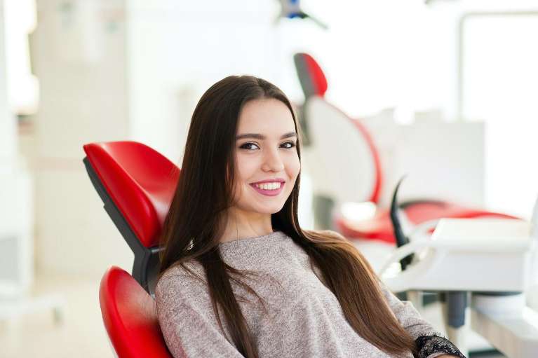 A smiling woman at the dentist | dentist Scottsdale