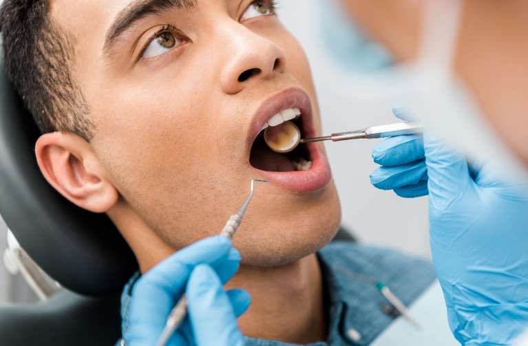 A man getting a dental exam and cleaning in scottsdale