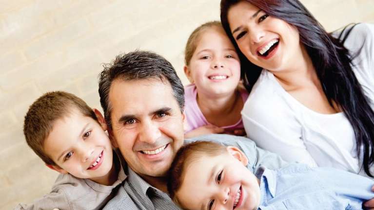 A laughing family sitting on the floor