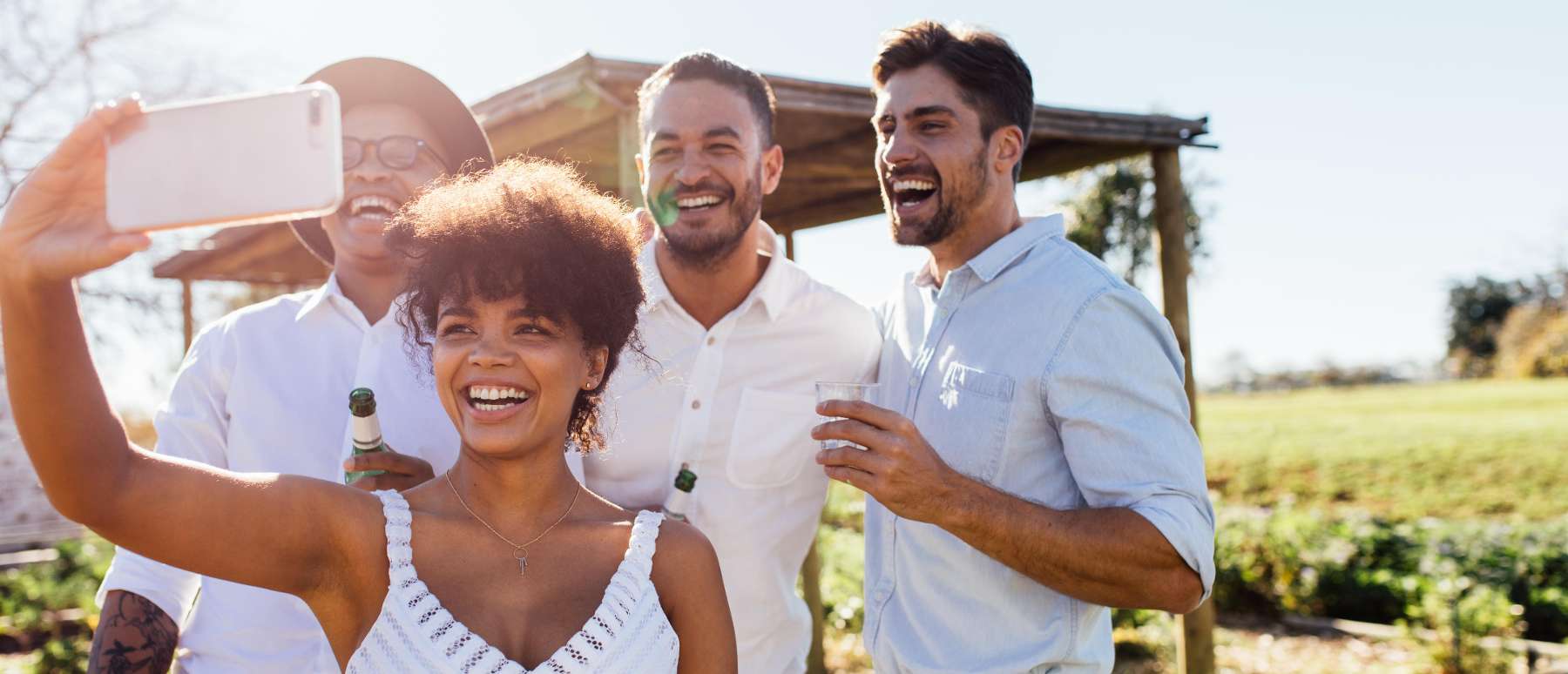 A family taking a selfie in a vineyard