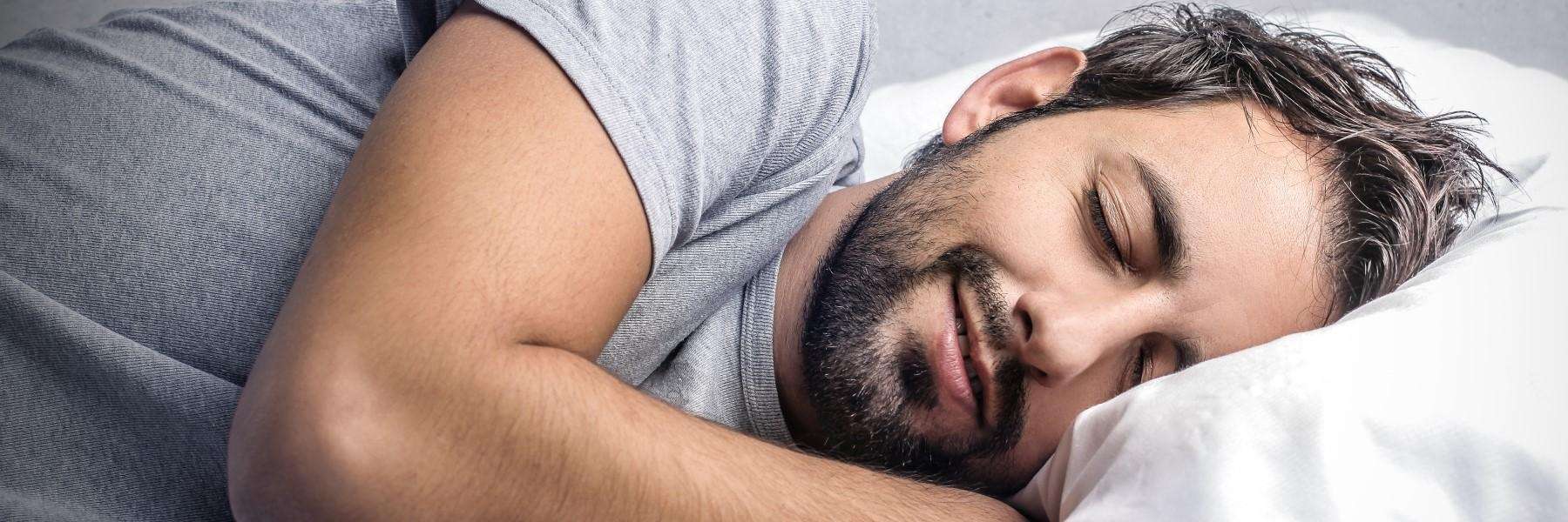 A man in bed peacefully sleeping