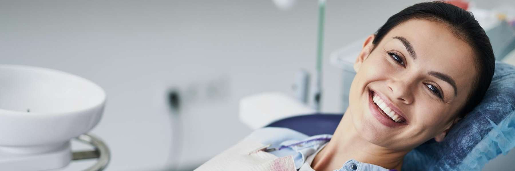 A smiling woman sitting in a dental operatory