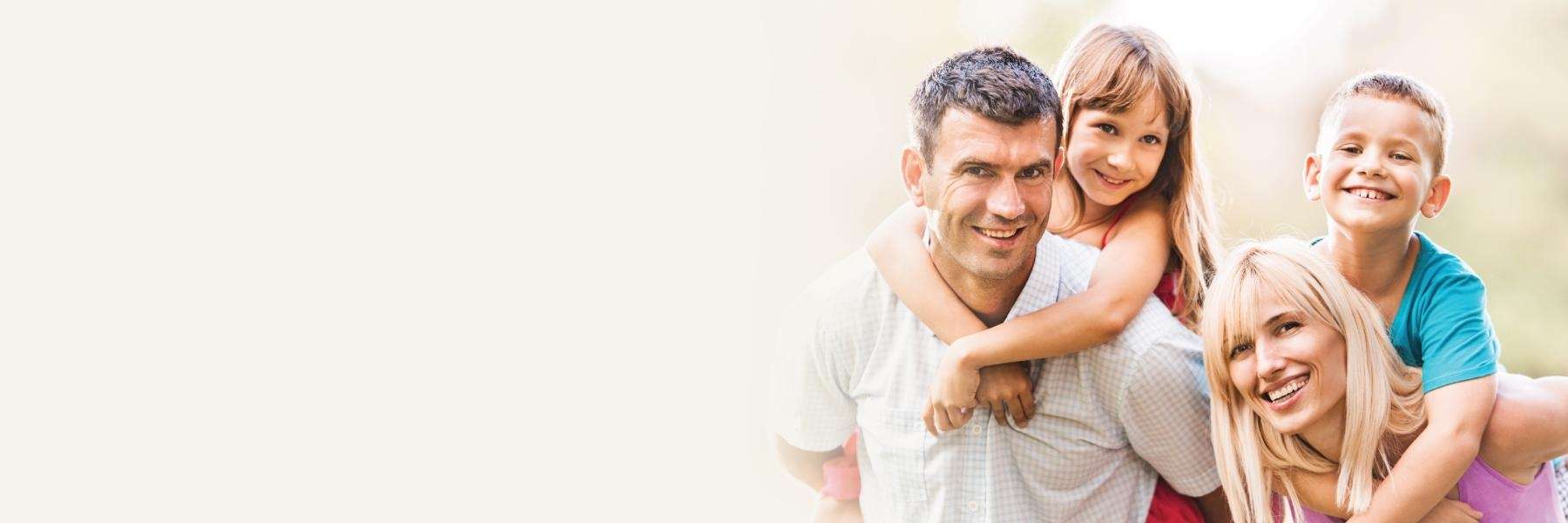 A smiling family posing outside | Scottsdale family dentist